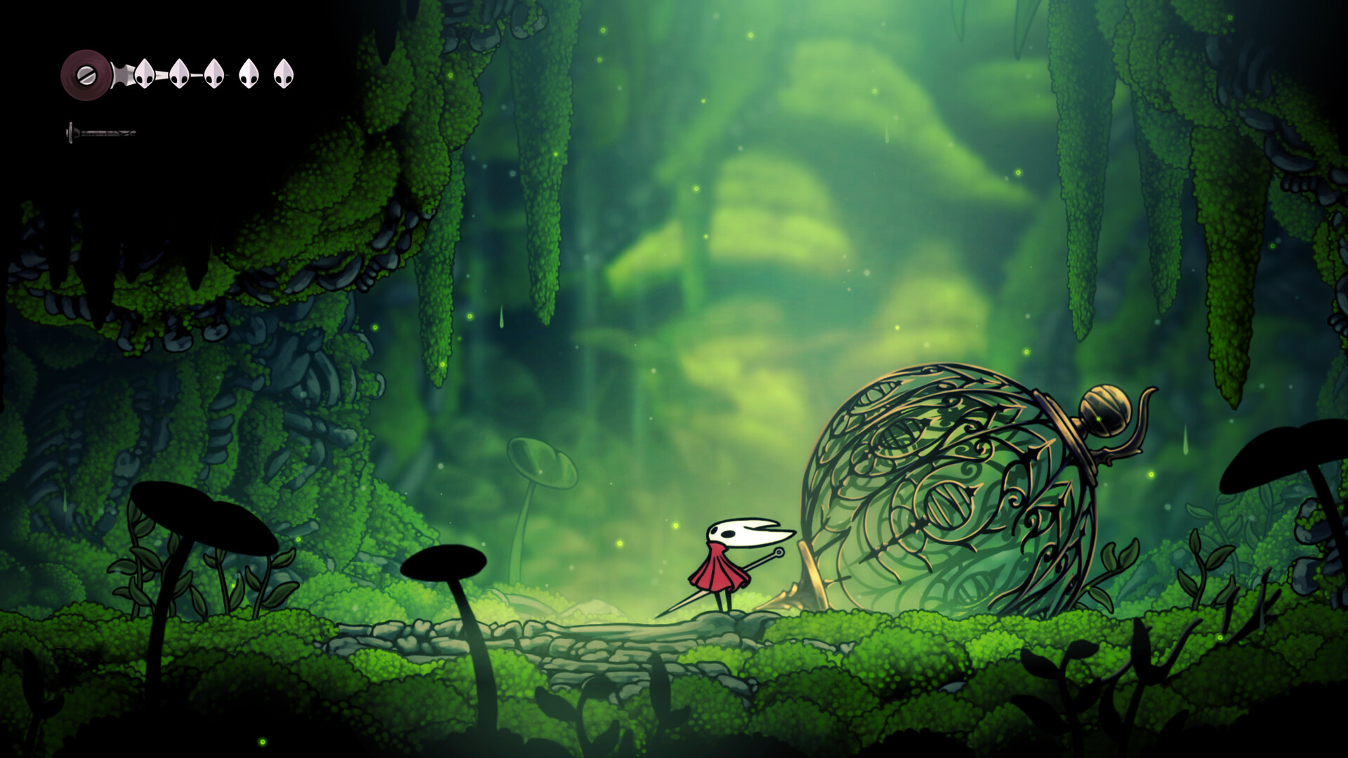 Hornet beside an ornate cage in a moss-covered cavern.